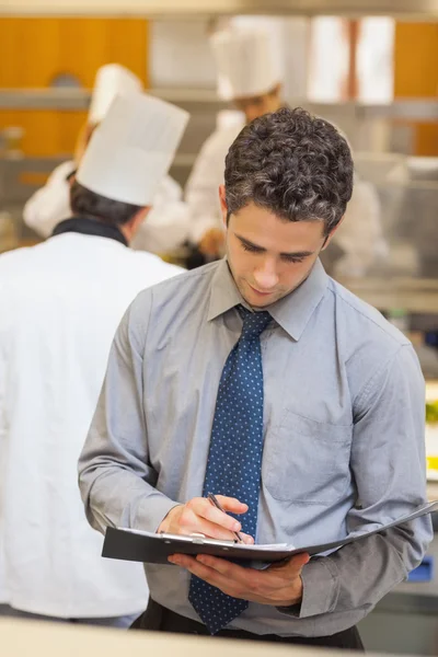 Waiter looking at folder — Stock Photo, Image