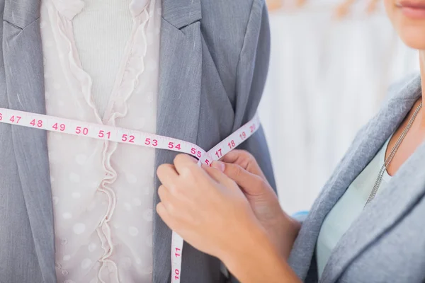 Fashion designer measuring blazer — Stock Photo, Image