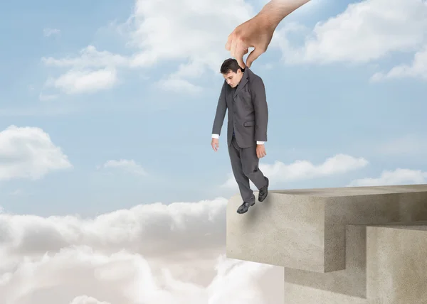 Giant hand dropping off a businessman over the clouds — Stock Photo, Image