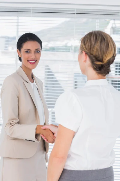 Cheerful coworkers shaking hands — Stock Photo, Image