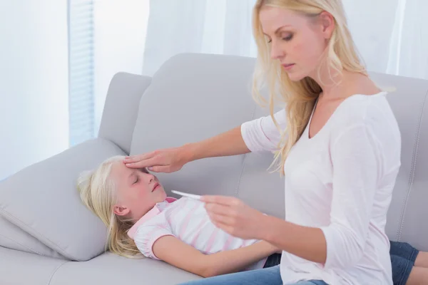 Mother taking care of her sick daughter — Stock Photo, Image