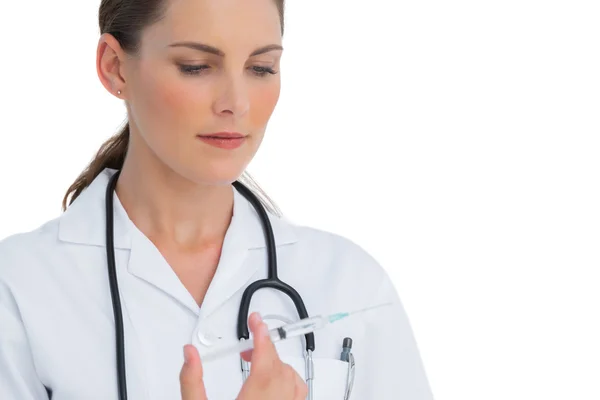 Serious nurse holding a syringe — Stock Photo, Image