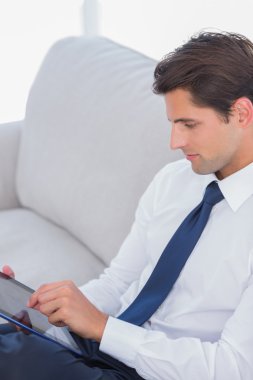 Businessman using digital tablet clipart