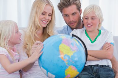 Smiling family with globe clipart