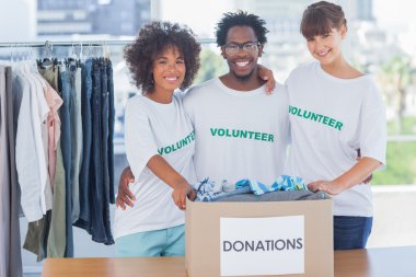 Volunteers standing together in their office clipart