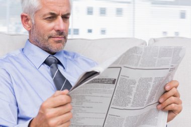 Businessman reading the news clipart