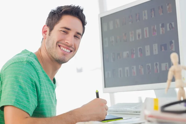 Cheerful photo editor working on graphics tablet — Stock Photo, Image