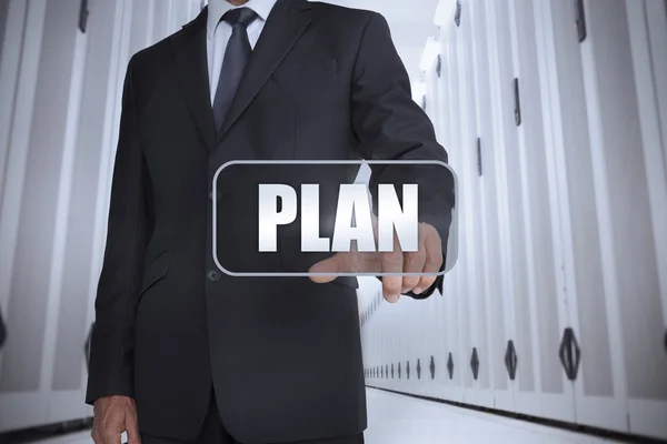 Businessman in a data center selecting label with plan — Stock Photo, Image