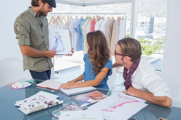 Fashion designer presenting his draw to colleagues — Stock Photo, Image