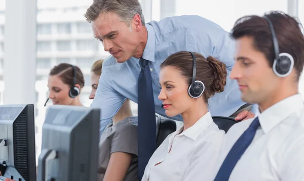 Manager helping call centre agent — Stock Photo, Image