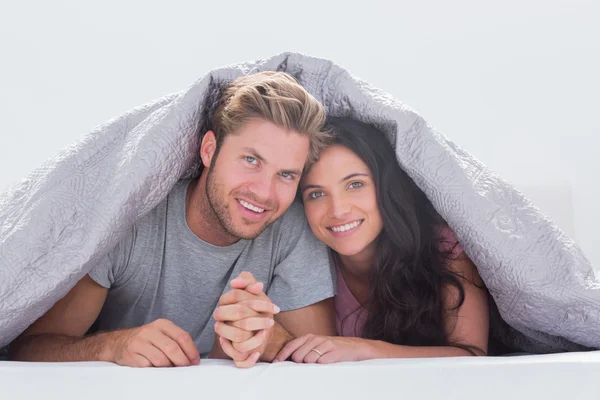 Красивая пара под одеялом — стоковое фото