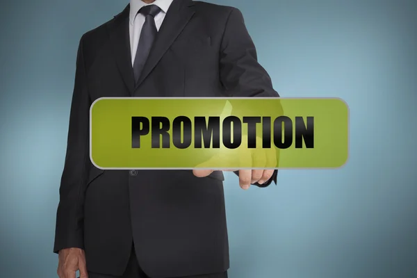 Businessman touching the word promotion written on green tag — Stock Photo, Image