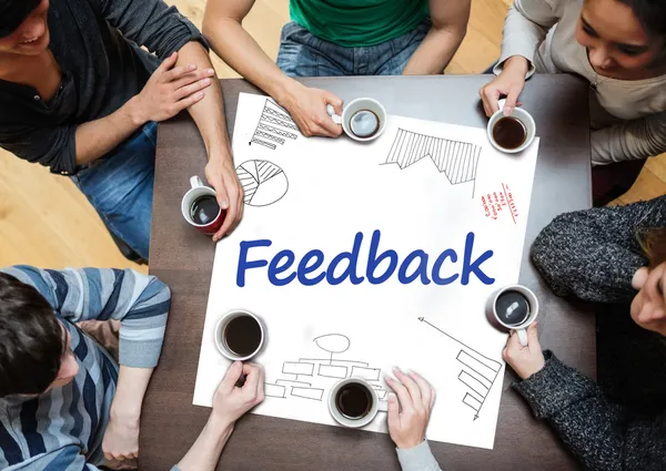 Feedback written on a poster with drawings of charts — Stock Photo, Image