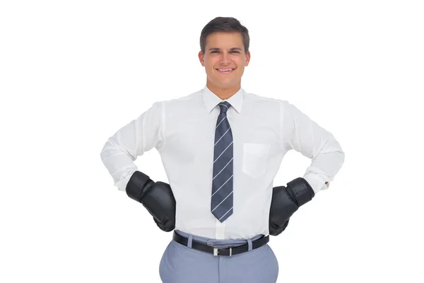 Businessman standing with black boxing gloves — Stock Photo, Image