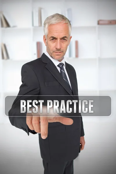 Serious businessman touching the term best practice — Stock Photo, Image