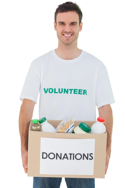 Hombre guapo llevando caja de donaciones con comida —  Fotos de Stock