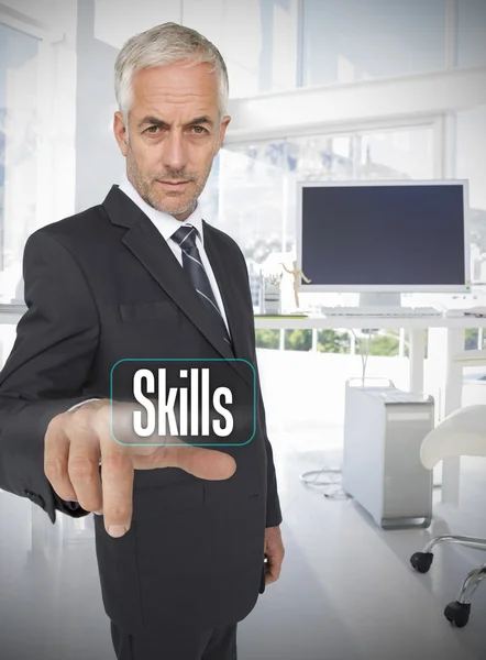 Businessman selecting the word skills — Stock Photo, Image