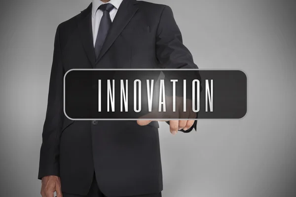 Affärsman välja etikett med innovation skrivet på det — Stockfoto