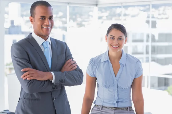 Confident business team smiling at camera — Stockfoto