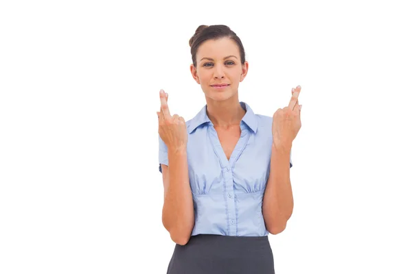 Smiling businesswoman with fingers crossed — Stock Photo, Image