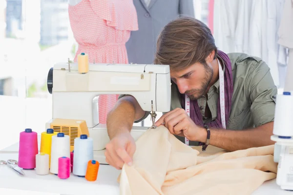 Handsome fashion designer sewing — Stock Photo, Image