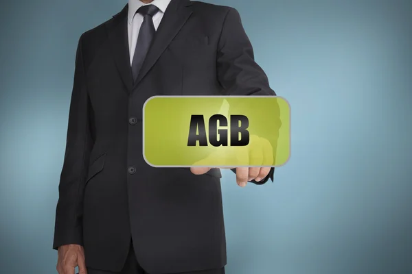 Businessman selecting green label with agb written on it — Stock Photo, Image