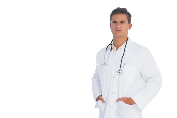 Doctor frowning with hands in pockets — Stock Photo, Image