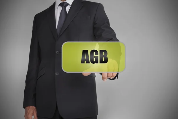 Uomo d'affari selezionando tag verde con la parola agb scritto su di esso — Foto Stock
