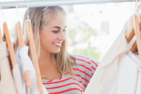 Cheerful woman looking at clothes — Stock Photo, Image