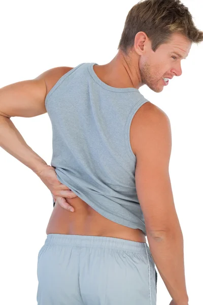 Homem sorrindo por causa de uma dor nas costas — Fotografia de Stock