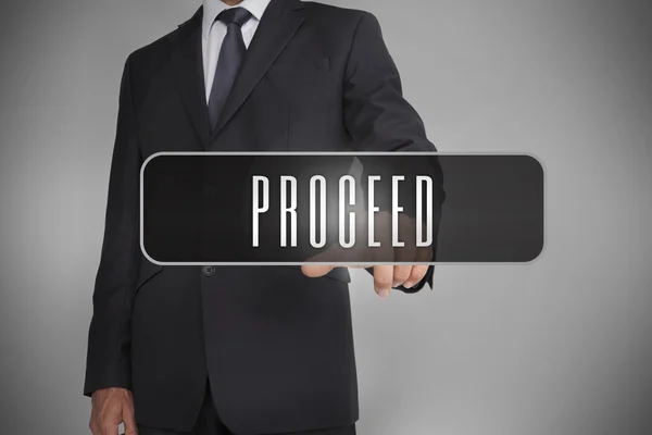 Businessman selecting label with proceed written on it — Stock Photo, Image