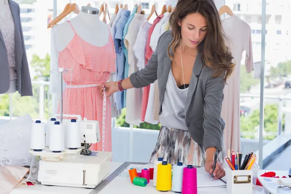 Fashion designer measuring a mannequin — Stock Photo, Image