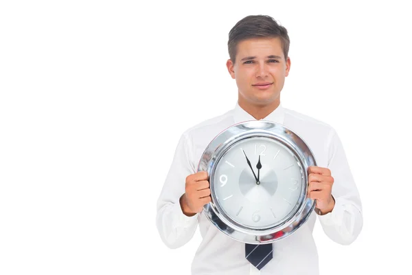 Nervous businessman holding a clock — Stock Photo, Image