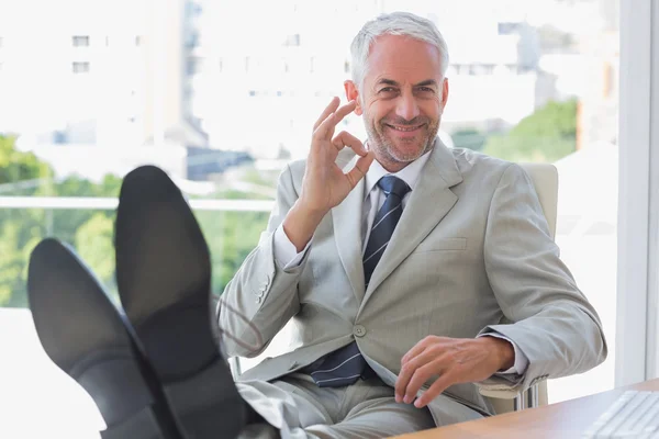 Smiling businessman giving ok sign — Stock Photo, Image