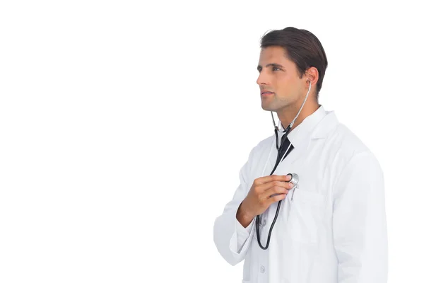 Serious doctor holding up stethoscope to his chest — Stock Photo, Image