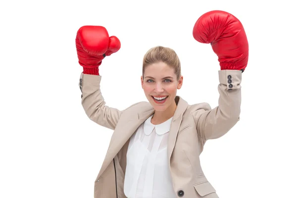 Cheering businesswoman wearing boxing gloves — Stock Photo, Image