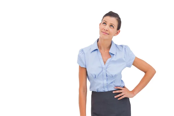 Businesswoman thinking with hand on hip — Stock Photo, Image