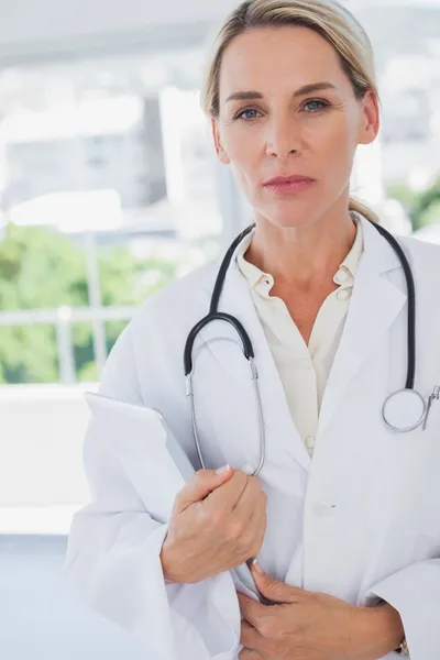 Serious blonde doctor standing — Stock Photo, Image