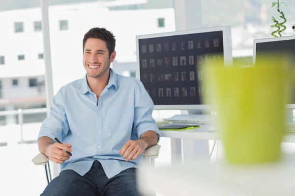 Cheerful photo editor in his swivel chair — Stock Photo, Image