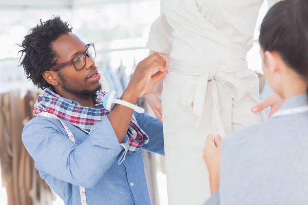 Fashion designers standing next to a model — Stock Photo, Image