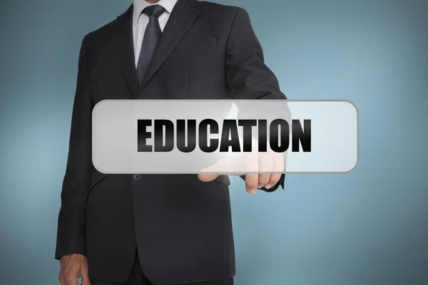 Businessman selecting the word education written on white tag — Stock Photo, Image