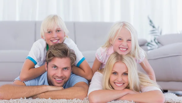 Parents and children lying on the carpet — Stock Photo, Image