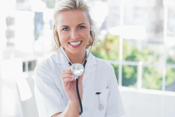 Strahlende Krankenschwester zeigt ihr Stethoskop — Stockfoto