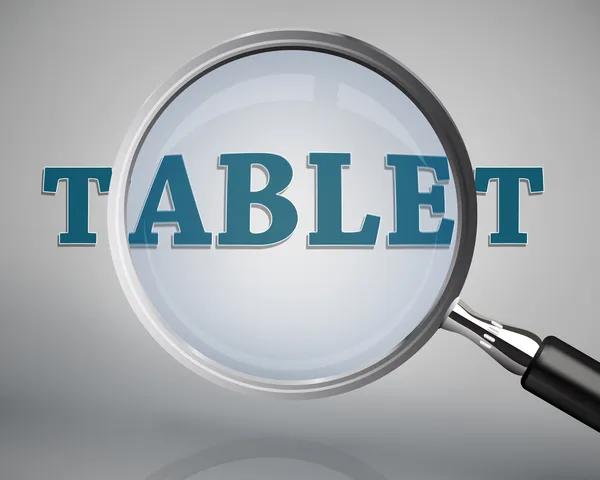 Magnifying glass showing tablet word — Stock Photo, Image