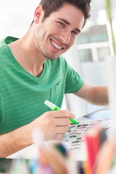 Cheerful photo editor working on a contact sheet — Stock Photo, Image