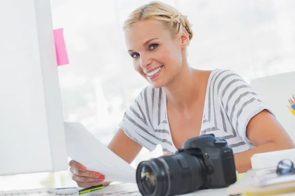 Blonde photo editor holding a contact sheet — Stock Photo, Image