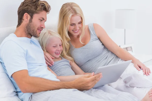 Couple using a laptop with their daughter — Stok fotoğraf