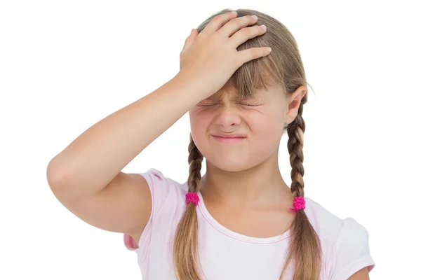 Little girl suffering from headache and touching her head — Stock Photo, Image