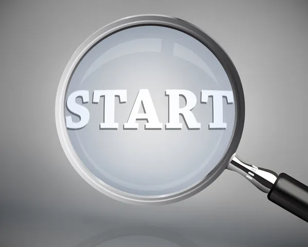 Magnifying glass showing start word in white — Stock Photo, Image