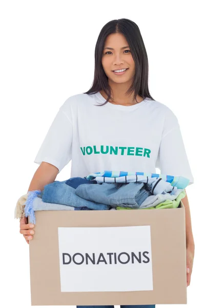 Happy woman carrying donation box — Stock Photo, Image